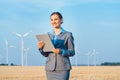 Investor in wind turbines with computer evaluating her investment