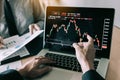 Investors are pointing to laptops that have investment information stock markets and partners taking notes and analyzing