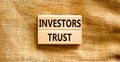 Investors trust symbol. Concept words Investors trust on wooden blocks on a beautiful canvas table canvas background. Business Royalty Free Stock Photo