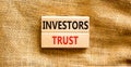 Investors trust symbol. Concept words Investors trust on wooden blocks on a beautiful canvas table canvas background. Business Royalty Free Stock Photo