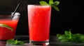Invigorating tall glass of refreshing watermelon juice garnished with a sprig of fresh mint, a slice of juicy watermelon, and ice