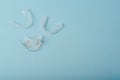 Invisalign braces or invisible retainer on blue background. Ortodontic model brace or bracket