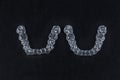 Before and after invisalign invisible brackets. Two transparent aligner retainers, one initial and one final of the same Royalty Free Stock Photo