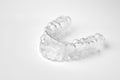 Invisible orthodontic removable braces on a white background with copy space. Aligners for straightening of teeth.