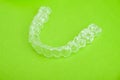 Invisible teeth aligners isolated on green background