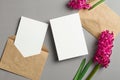 Invitation card mockup, front and back sides with envelope and spring hyacinth flowers on grey Royalty Free Stock Photo