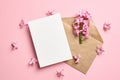 Invitation or greeting card mockup with envelope and hyacinth flowers on pink background Royalty Free Stock Photo