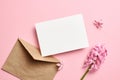 Invitation or greeting card mockup with envelope and hyacinth flowers on pink background Royalty Free Stock Photo