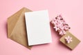 Invitation or greeting card mockup with envelope and hyacinth flowers on pink background Royalty Free Stock Photo