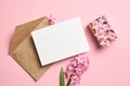Invitation or greeting card mockup with envelope and hyacinth flowers on pink background Royalty Free Stock Photo
