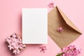 Invitation or greeting card mockup with envelope and hyacinth flowers on pink background Royalty Free Stock Photo