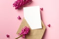 Invitation or greeting card mockup with envelope and hyacinth flowers on pink paper background Royalty Free Stock Photo