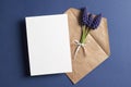 Invitation or greeting card mockup with envelope and spring blue muscari flowers Royalty Free Stock Photo