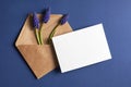 Invitation or greeting card mockup with envelope and spring blue muscari flowers Royalty Free Stock Photo