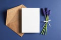 Invitation or greeting card mockup with envelope and spring blue muscari flowers Royalty Free Stock Photo
