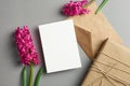 Invitation or greeting card mockup with hyacinth flowers, envelope and gift box on grey Royalty Free Stock Photo