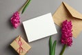 Invitation or greeting card mockup with hyacinth flowers, envelope and gift box on grey Royalty Free Stock Photo