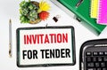 Invitation for tender. A text label in the planning notebook.