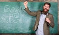 Invitation to celebrate knowledge day. Teacher or educator welcomes students while stands near chalkboard with Royalty Free Stock Photo