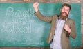 Invitation to celebrate knowledge day. Teacher or educator welcomes students while stands near chalkboard with Royalty Free Stock Photo