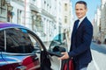 Joyful polite man pointing to the car seat