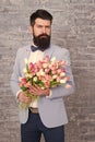 Invite her dating. Romantic man with flowers. Romantic gift. Macho getting ready romantic date. Waiting for darling Royalty Free Stock Photo