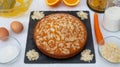 An inviting carrot cake with almond flakes. Made at the grandmother`s house. Ingredients and equipment on the table