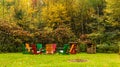 Wooden adirondack chairs arranged in a circle around a fire pit Royalty Free Stock Photo