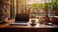 Laptop and coffee cup on wooden table in coffee shop, stock photo