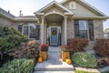 Inviting front entrance of a house with holloween ornaments at the front of the gray door