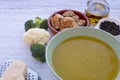 An inviting and healthy creamy homemade vegetable soup fresh and ready to eat. Made with cauliflower potatoes, peas, celery and Royalty Free Stock Photo