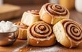 Inviting rustic food presentation with cinnamon rolls stacked neatly beside sugar cubes glowing with warmth Royalty Free Stock Photo