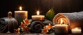 An Inviting Spa Setting With Lit Candles, Dark Stones, Orange Orchid Flowers, And Plush Towels On A Dark Wooden Surface
