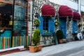 Vintage Restaurant Window With Colorful Shutters And Umbrella