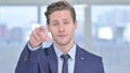 Inviting Young Businessman Pointing with Finger