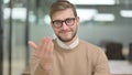 Inviting Young Man Pointing at the Camera