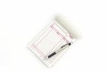 Invoice book which open blank page with pen.