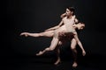 Involved ballet dancers performing together in the studio