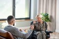 Servicewoman involved in conversation with young psychoanalyst