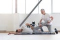 Involved physical therapist stretching the handicapped in the gym Royalty Free Stock Photo