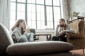 Bearded therapist feeling involved in problem of teenager