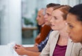 Involved in a skills development seminar. A group of business people listening to a presentation at a seminar. Royalty Free Stock Photo