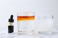 Iodine starch test. Bottle of aqueous iodine, glasses with water-dissolved iodine and starch solution on white marble table, Royalty Free Stock Photo
