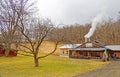 Maple sugar house with steam from smokestack Royalty Free Stock Photo