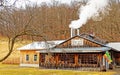 Maple sugar house with steam from smokestack Royalty Free Stock Photo