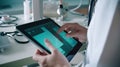 IoT in healthcare: Doctor\'s hand with stethoscope and tablet for remote patient check.