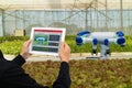 Iot smart industry robot 4.0 agriculture concept,industrial agronomist,farmer using tablet to monitor, control the condition in ve Royalty Free Stock Photo