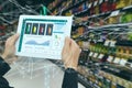 Iot smart retail in the futuristic concept, the retailer hold the tablet and use augmented reality technology monitor data of out