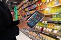 iot smart retail in the futuristic concept, the retailer hold the tablet and use augmented reality technology monitor data of out