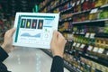 Iot smart retail in the futuristic concept, the retailer hold the tablet and use augmented reality technology monitor data of out Royalty Free Stock Photo